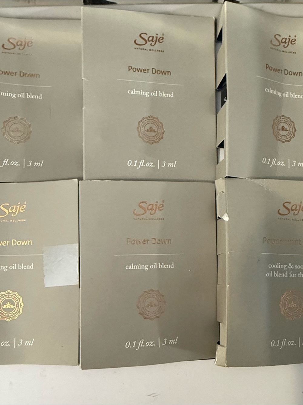 Saje Power Down Calming Oil Blend - Beige and Gold Packets